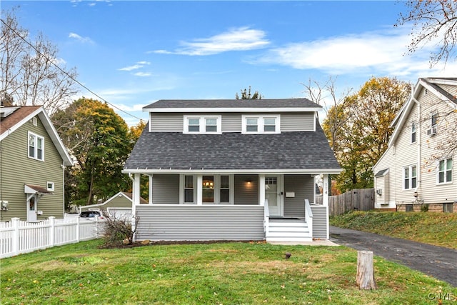 bungalow-style home with a front yard and covered porch