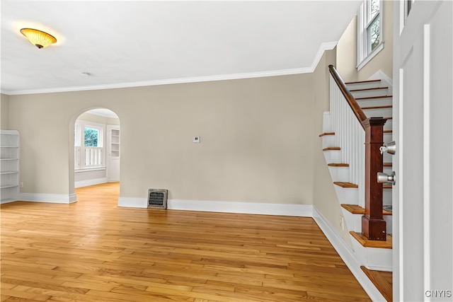 interior space featuring ornamental molding and light hardwood / wood-style floors