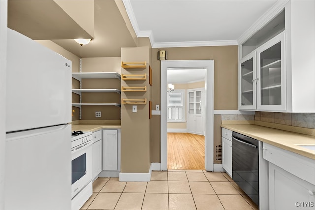 kitchen featuring white cabinetry, light tile patterned floors, white appliances, and crown molding