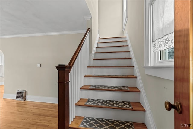 stairway featuring hardwood / wood-style flooring and crown molding