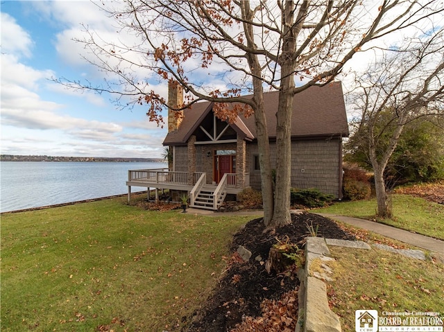 view of front of home with a deck with water view and a front yard