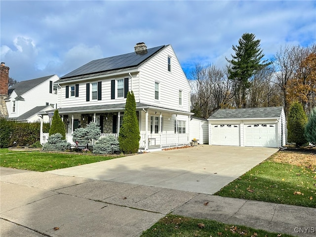 view of front of property featuring solar panels, a porch, a front lawn, a garage, and an outdoor structure