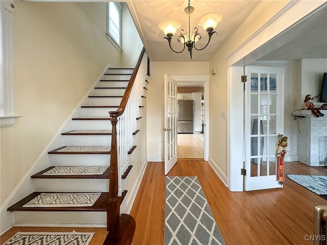 interior space with wood-type flooring and a chandelier