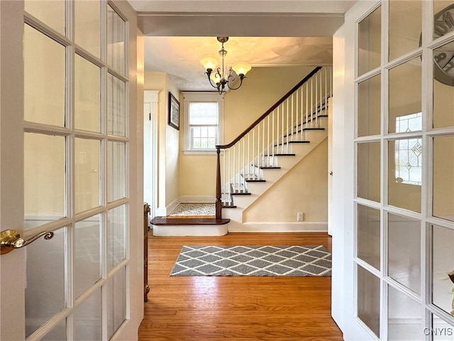 foyer featuring a notable chandelier and hardwood / wood-style flooring