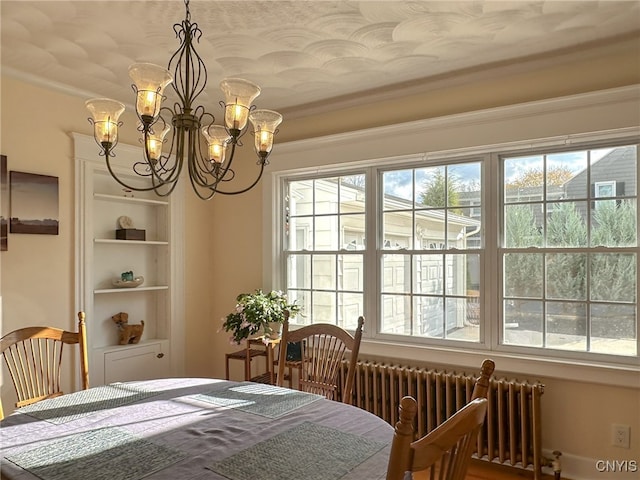 dining room with radiator, an inviting chandelier, and crown molding