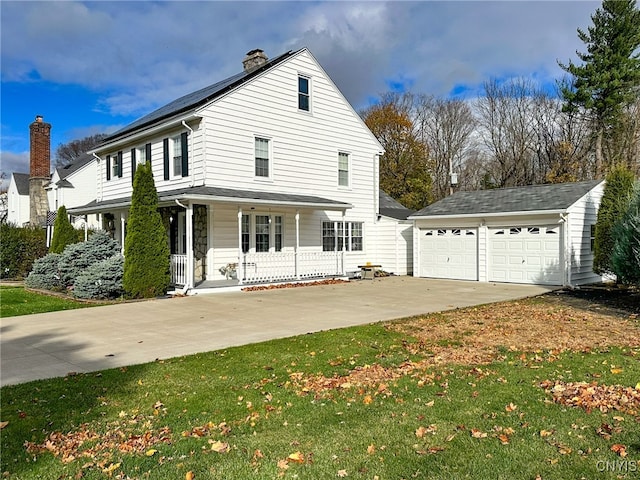 view of front facade featuring an outbuilding, a garage, a front lawn, and a porch