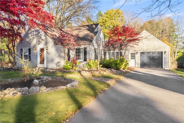 cape cod-style house with a garage and a front yard