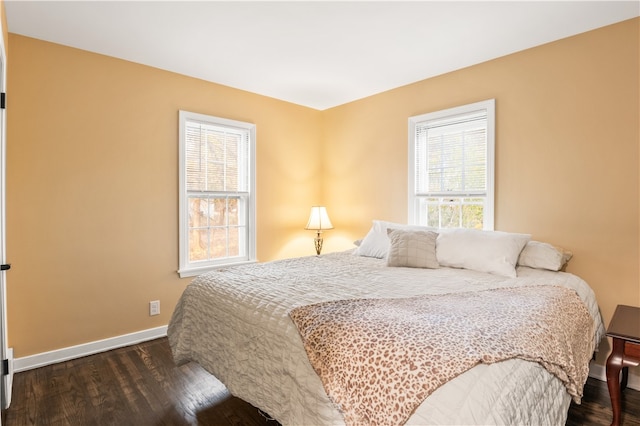 bedroom with dark hardwood / wood-style floors