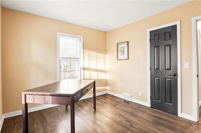 home office with dark hardwood / wood-style flooring