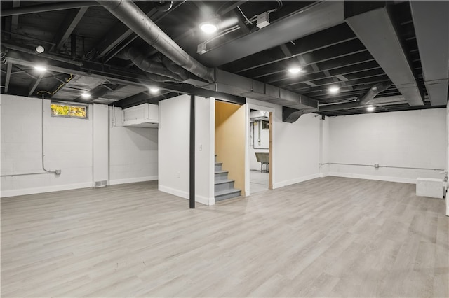 basement featuring light hardwood / wood-style flooring