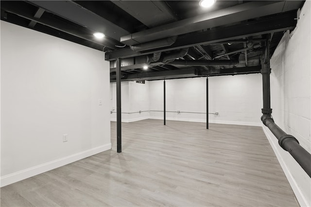 basement with hardwood / wood-style flooring