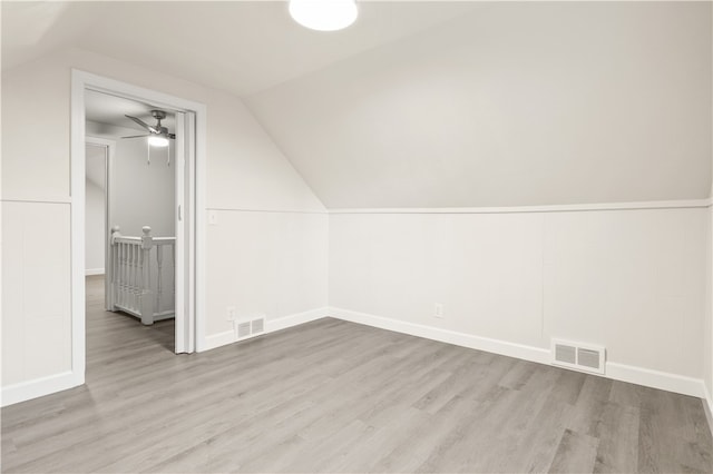 additional living space featuring light wood-type flooring, vaulted ceiling, and ceiling fan