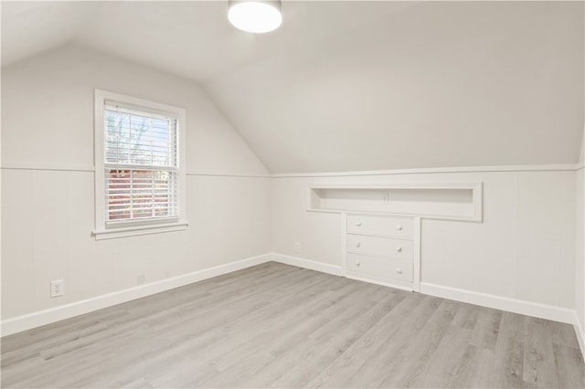 bonus room with lofted ceiling and light hardwood / wood-style floors