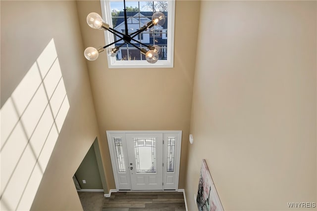 foyer featuring hardwood / wood-style flooring and a towering ceiling