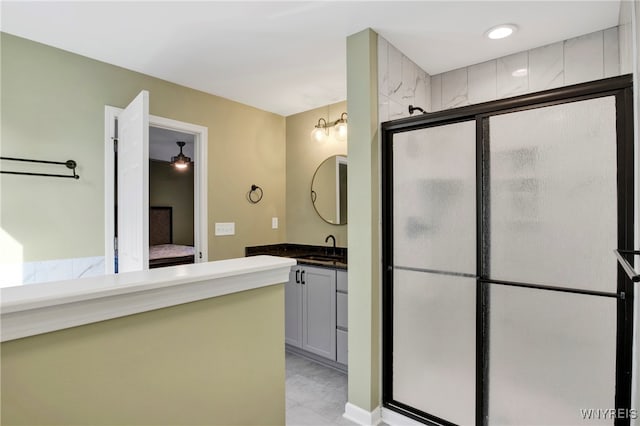 bathroom featuring vanity and a shower with shower door