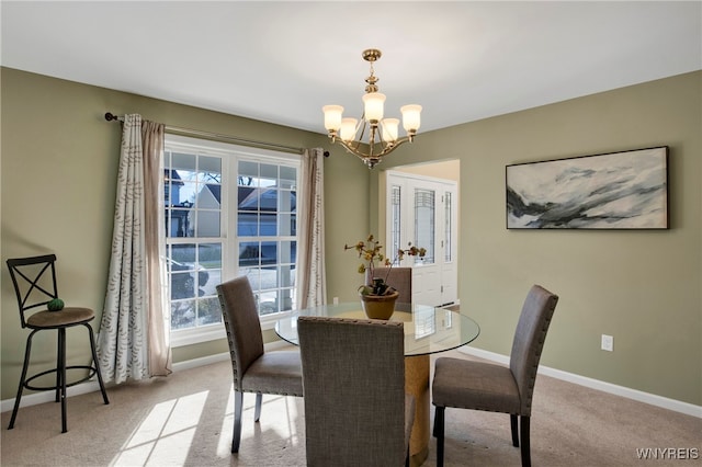 carpeted dining space with a notable chandelier and a healthy amount of sunlight