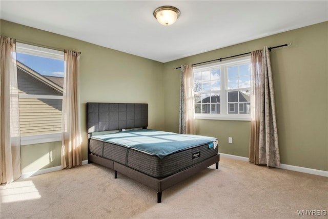 carpeted bedroom featuring multiple windows