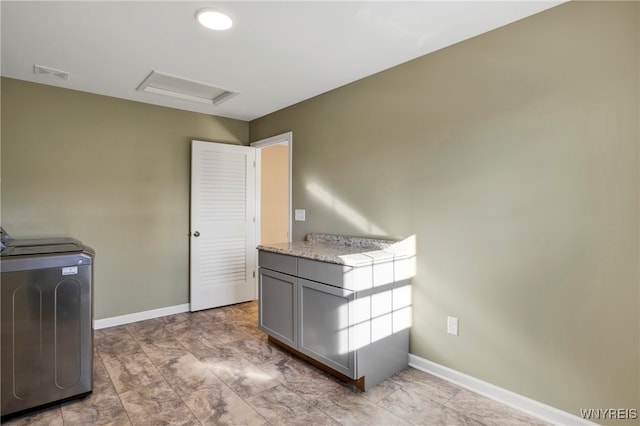 washroom with cabinets and washer / dryer