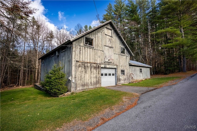 view of home's exterior with a garage and a yard