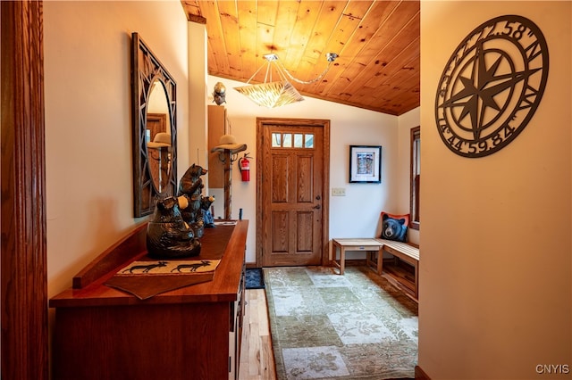 entryway with lofted ceiling, hardwood / wood-style floors, and wooden ceiling