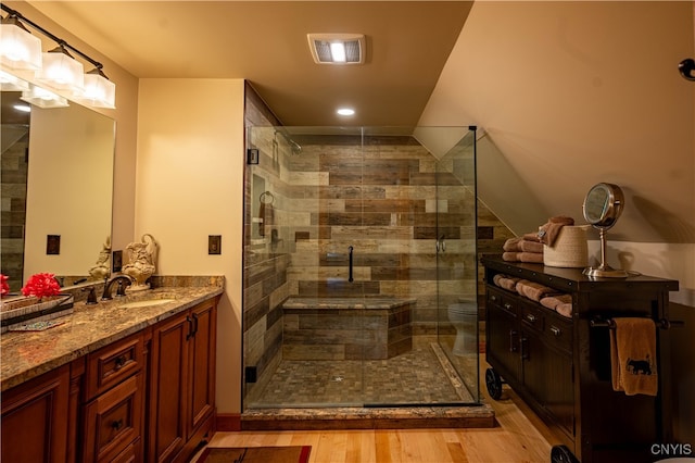 bathroom featuring an enclosed shower, wood-type flooring, toilet, and vanity