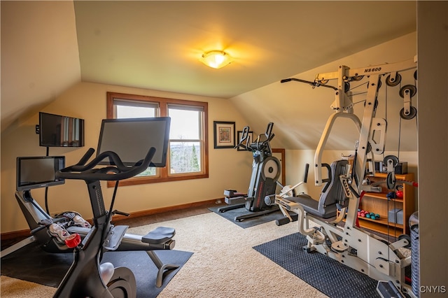 workout room with vaulted ceiling and carpet floors