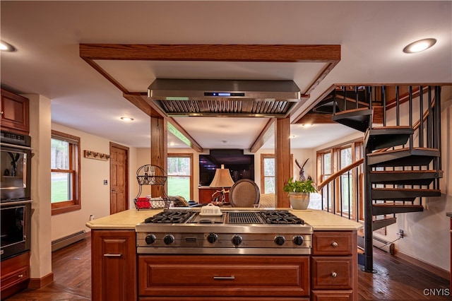 kitchen with a healthy amount of sunlight, black double oven, baseboard heating, and stainless steel gas stovetop