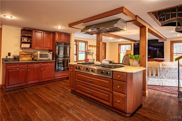 kitchen with stainless steel gas cooktop, plenty of natural light, black double oven, and dark hardwood / wood-style flooring