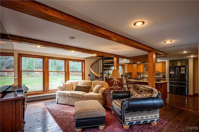 living room with hardwood / wood-style flooring, beamed ceiling, and a baseboard heating unit