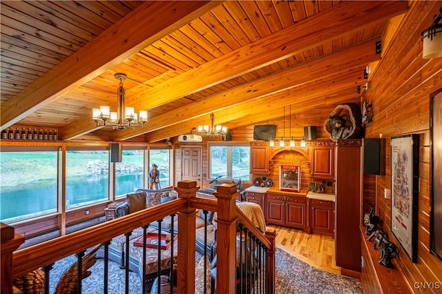 dining area featuring wood walls, an inviting chandelier, wood ceiling, vaulted ceiling with beams, and light wood-type flooring