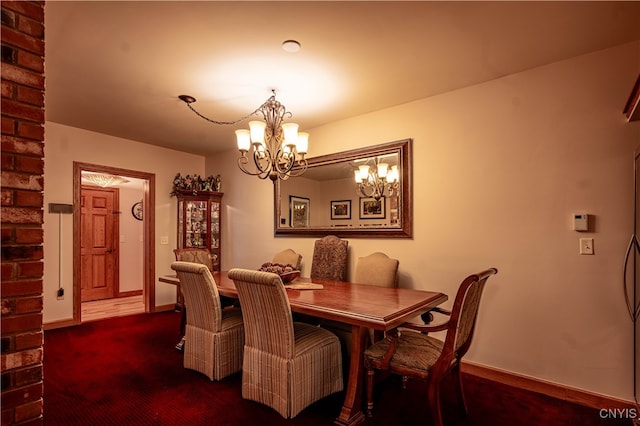 carpeted dining space with a chandelier