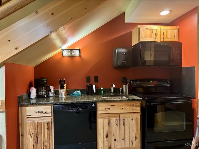 kitchen featuring lofted ceiling, dark stone counters, black appliances, sink, and light brown cabinetry