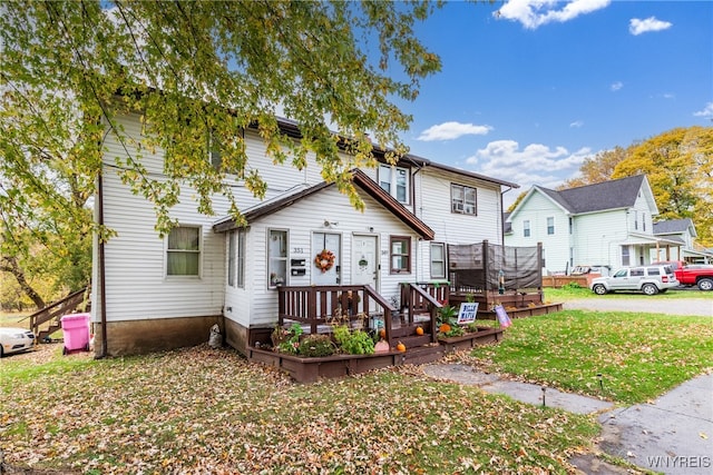 view of front facade with a front yard and a deck