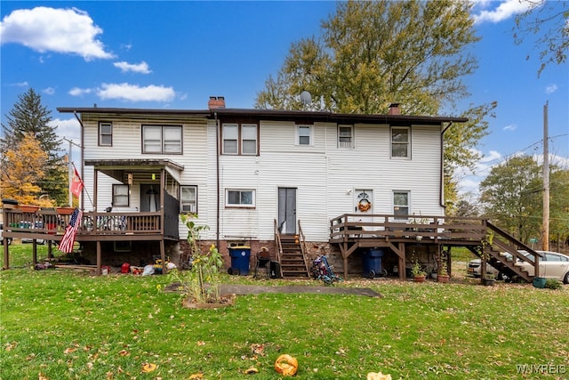 back of house featuring a deck and a yard