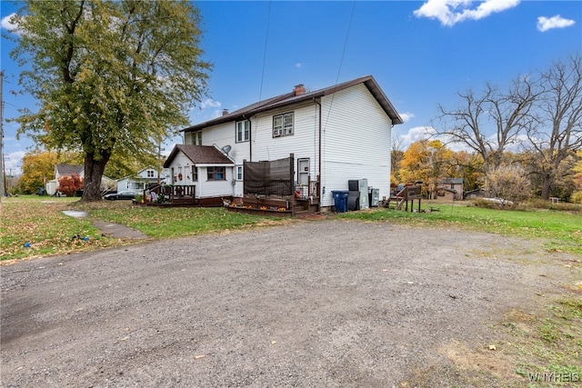 rear view of property featuring a deck