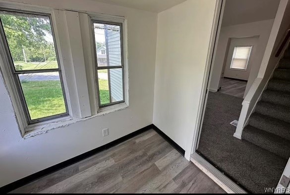 unfurnished room with hardwood / wood-style floors