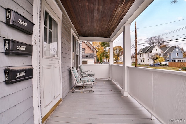 wooden terrace featuring covered porch