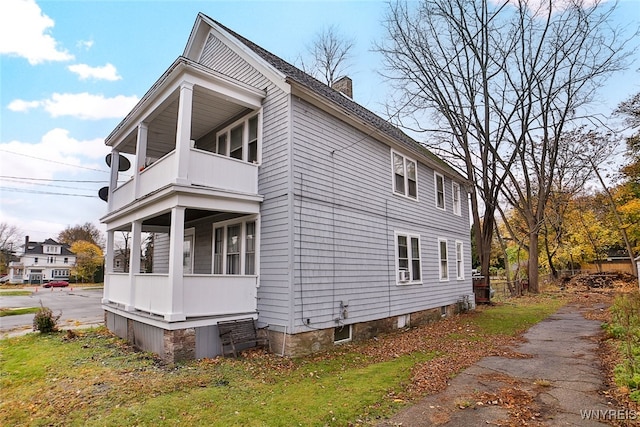 view of side of home with a balcony