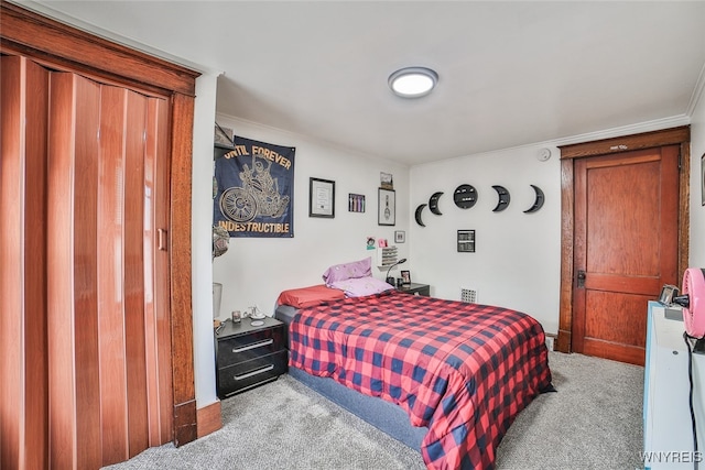 carpeted bedroom with ornamental molding