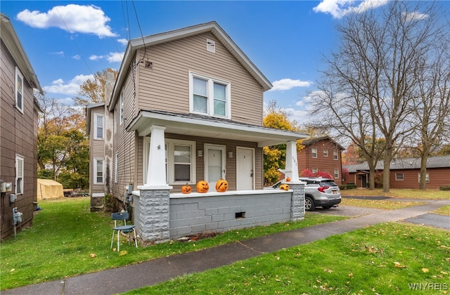 view of front of property with a porch and a front yard