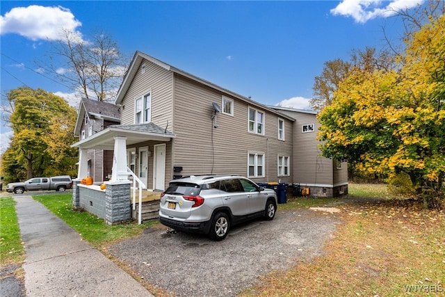 view of side of property with a porch