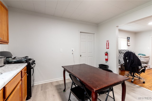 office space with ornamental molding and light wood-type flooring