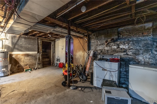 basement with water heater, washer / dryer, and white refrigerator