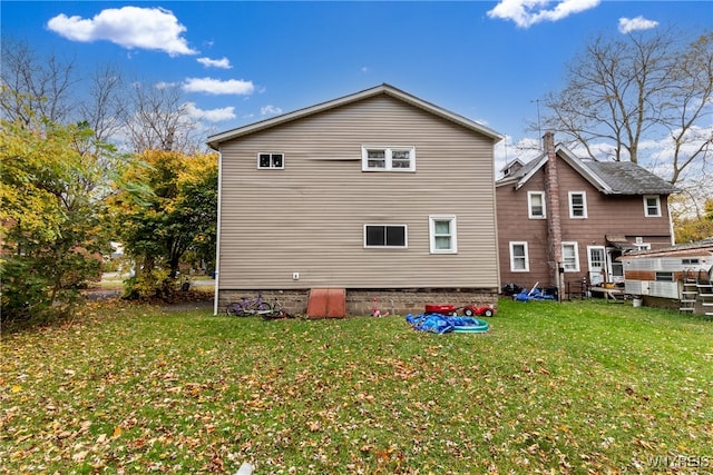 rear view of property with a yard