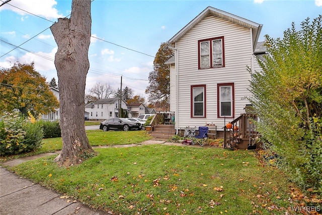 view of side of property featuring a yard