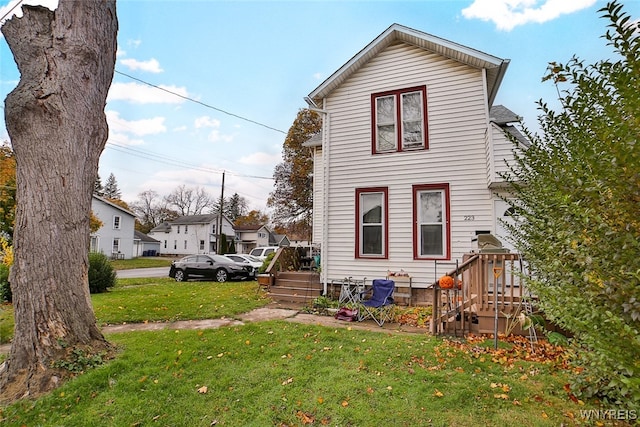 rear view of property with a lawn