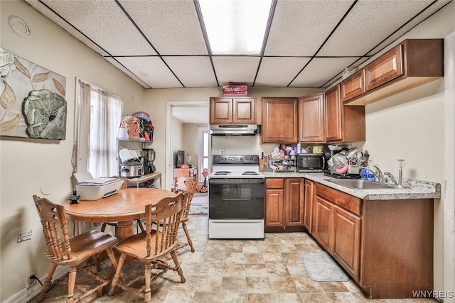 kitchen featuring a paneled ceiling, sink, and white electric stove