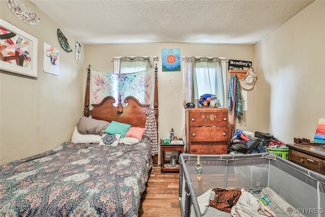 bedroom featuring a textured ceiling and light wood-type flooring