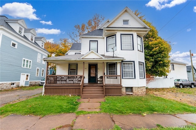 victorian-style house with covered porch and a front yard