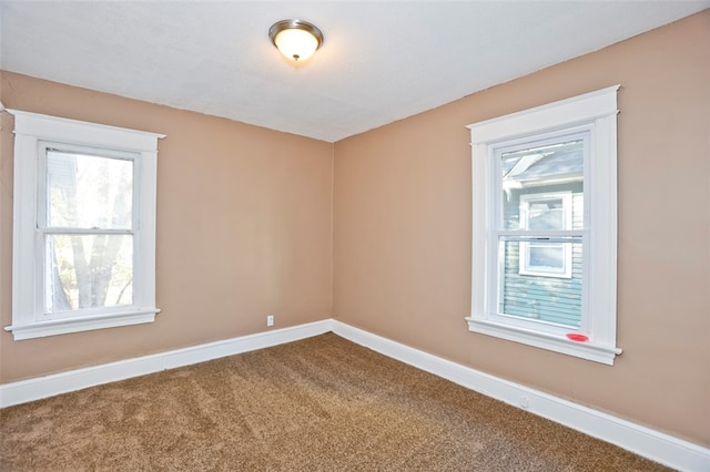 unfurnished room featuring carpet